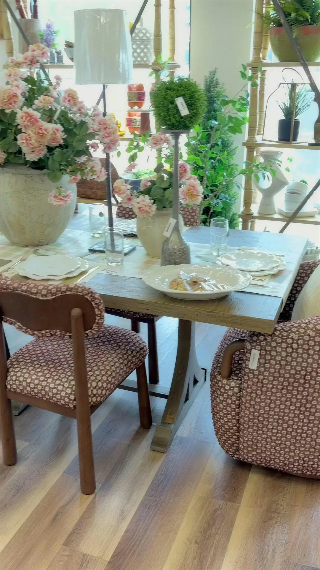 Dining table set with plates, glasses and pink florals